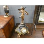 Gilt clock on marble stand with winged cherub decoration