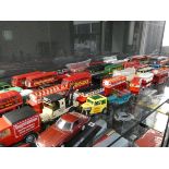 Shelf of various diecast cars and buses