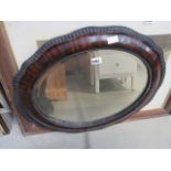 Oval bevelled mirror in walnut frame