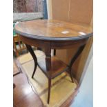 A circular inlaid walnut occasional table with second tier