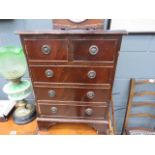 A reproduction mahogany miniature chest of two over three drawers