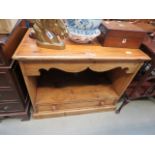 A pine TV cabinet with drawer under