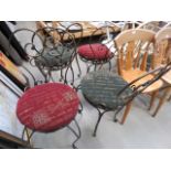 Four wrought iron dining chairs