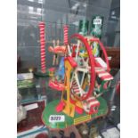 3 tin plate wind up fairground models to include a merry-go round, carousel and a gymnast