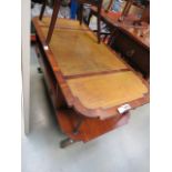 A walnut two tier coffee table with brown leather inlay