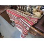 Striped decorated rug with tassels