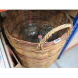 A wicker basket and three demijohns