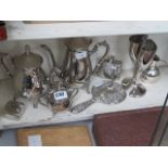 Silver plated tea service plus sugar tongs, hip flasks, salt and pepper and a silver mounted mirror