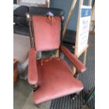 A pink upholstered Victorian armchair