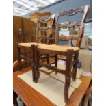 Pair of carved dining chairs with rush seats