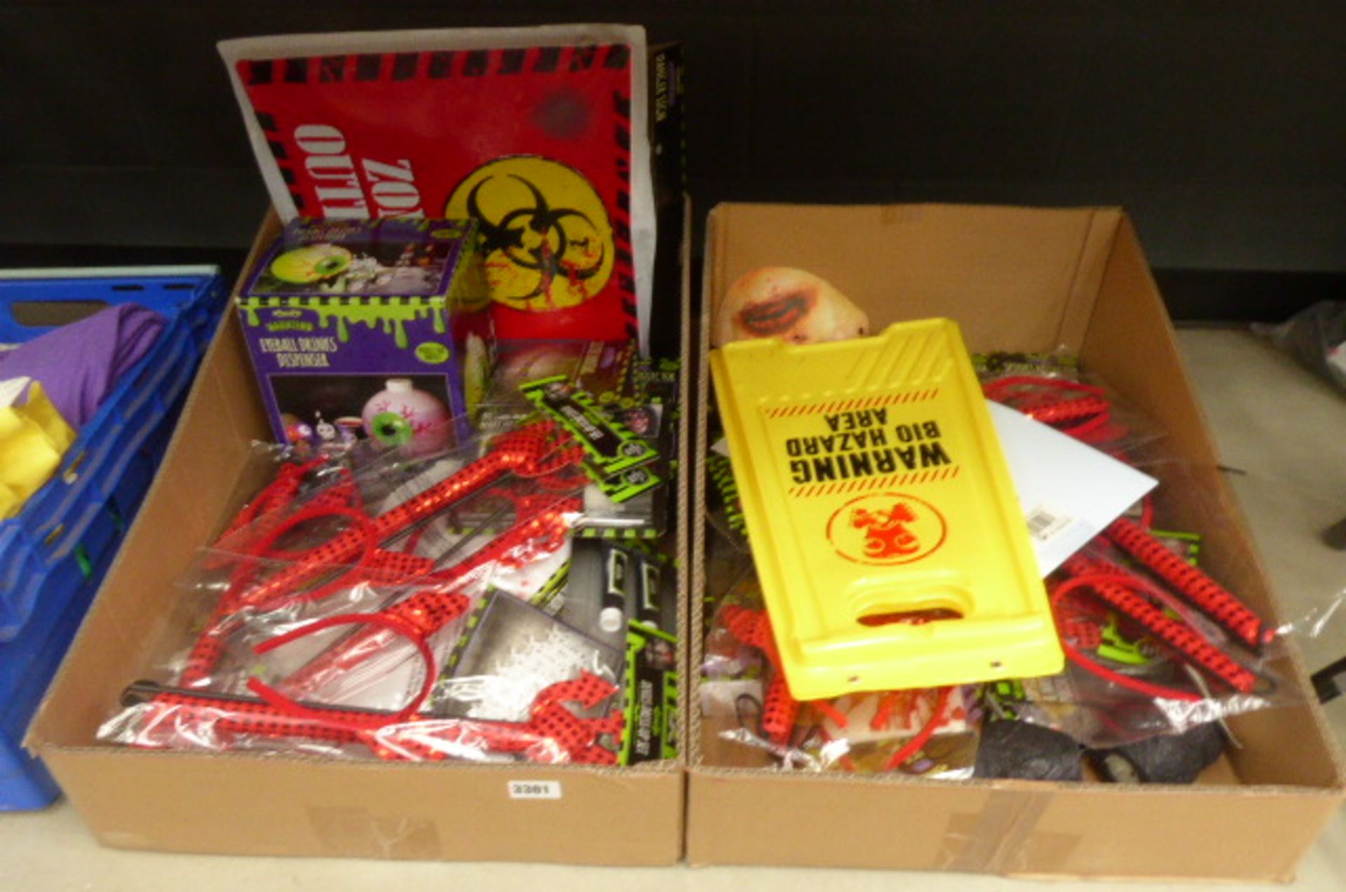 2 Large trays containing various Haloween items to inc. eyeball drinks dispensers, hazard signs, etc