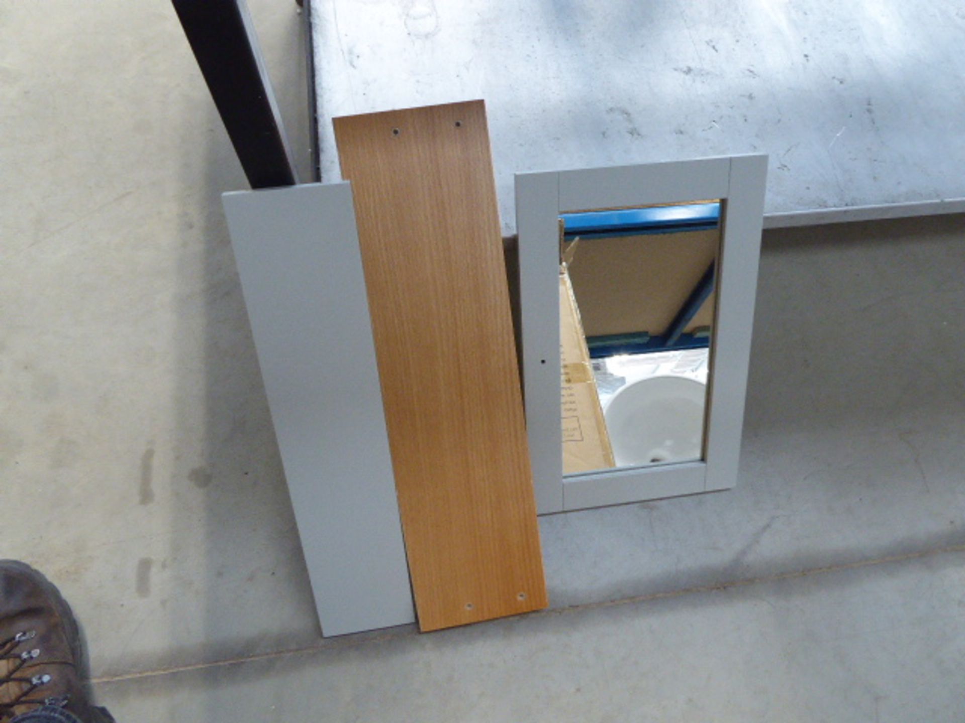 A flat pack mirrored bathroom cabinet