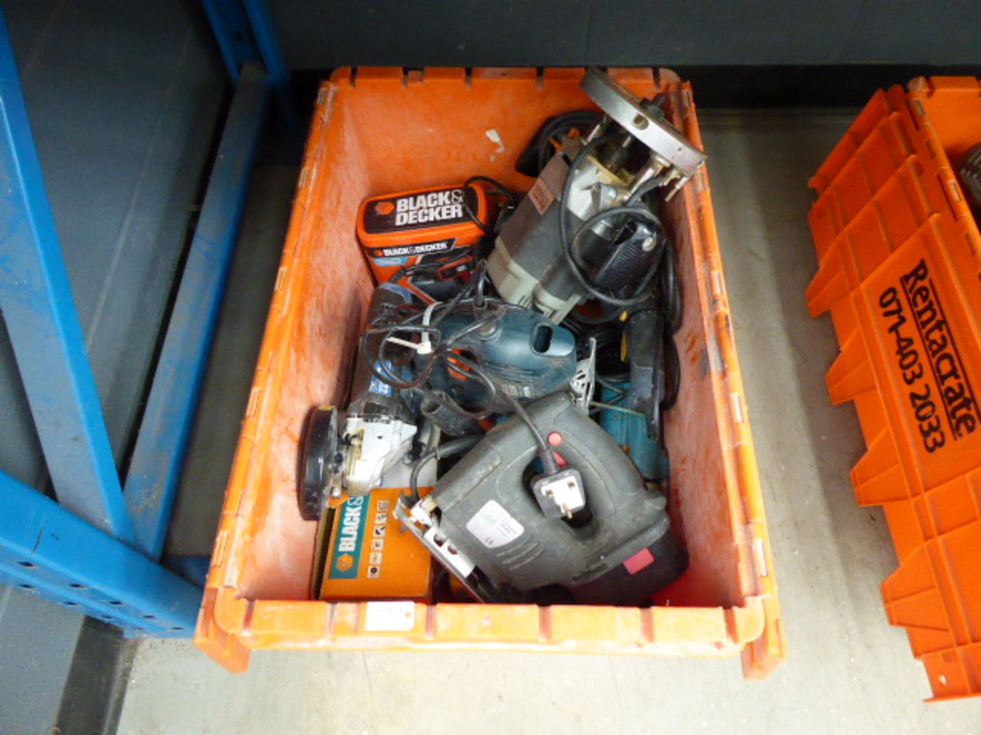 Orange plastic box containing router, jigsaws, angle grinder and various other tools