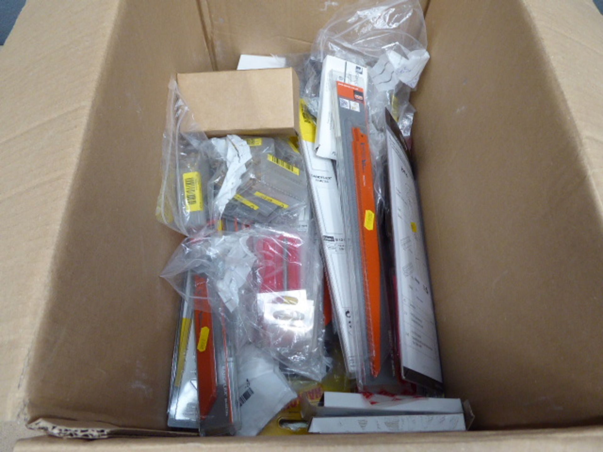 Box containing drill bits, clamping tools, wire strippers, blades, etc