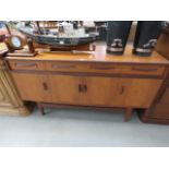 A G-Plan Fresco teak sideboard of three drawers over four doors