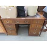 An oak twin pedestal desk with brown leather liner