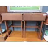 A pair of teak bedside cabinets