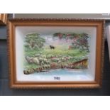 A framed ceramic picture of a shepherd and sheep