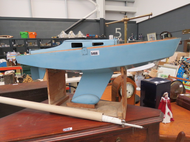 Light blue painted pong yacht on stand