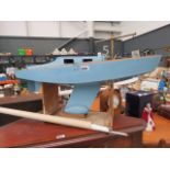 Light blue painted pong yacht on stand