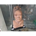 A terracotta bust of a young lady