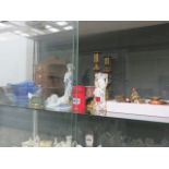 A shelf of assorted ornamental items, to include: brass & copper miniatures, candlesticks, religious