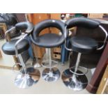 3 black topped chrome based bar stools