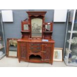 A mirror backed sideboard, with decorative carved panels