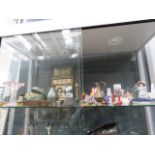 A large shelf of assorted items, to include: dog figurines, house figurines, collectible tins,