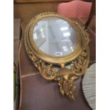 Pair of oval ornately framed mirrors