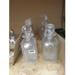 Six assorted spirit decanters with silver markers