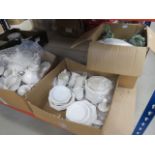 Three boxes of white china to include plates, coffee cups, teapots, gravy boats etc