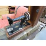 A dark wood cased Singer sewing machine
