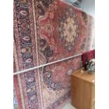 10 - Large carpet with red blue and cream floral and geometric design