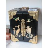 A lacquered Oriental Chinese jewellery box with mother of pearl inlay