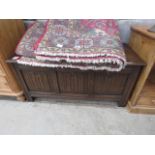 Dark wood lidded blanket box with linen fold panels
