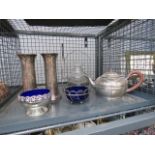 A cage of a small quantity of white metalware, to include: teapot, blue glass, metal trinket bowls