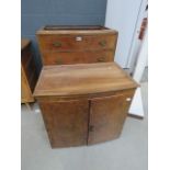 A walnut two door over four drawer chest of drawers