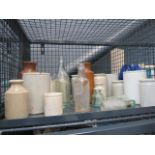 A cage of assorted collectable glass bottles and stoneware vases