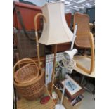 A wooden standard lamp with baise shade