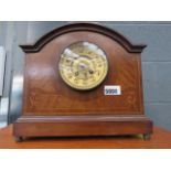 A dark wood mantel clock
