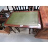 Nest of three tables with green leather inserts
