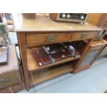 An oak butler's serving unit of two drawers over two shelves