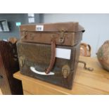 A small brown Rexine carry case, containing records singles and one gramophone