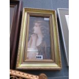 A pre-Raphaelite print of a girl in gold gilt frame