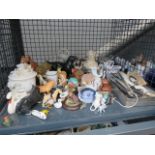 A cage of assorted items, to include: dog figurines, wild animal figurines, paperweights, fans,