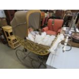 5307 - A child's pram with wicker decoration and two dolls