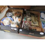 Two boxes of assorted household ware to include cutlery, tongs, trivets, desk tidies, fox