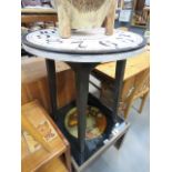 An occasional table with clock face front on black support