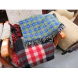 Blue and green checkered throw and a red and black woven blanket